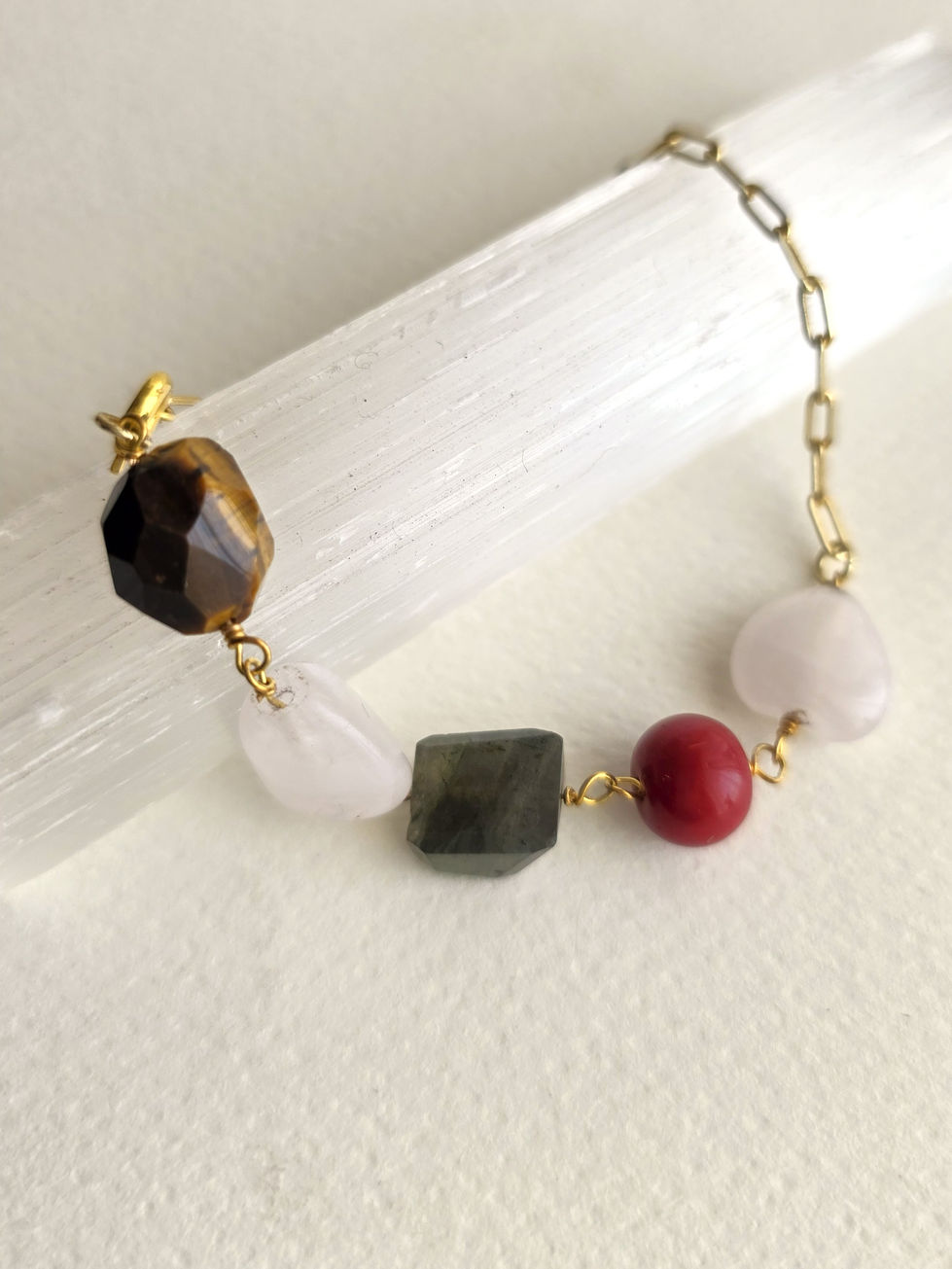Moon’s Tribe natural gemstone jewelry featuring faceted tiger’s eye, rose quartz, labradorite and red beads with gold-tone