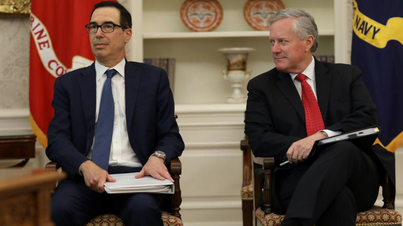 FILE PHOTO: U.S. Treasury Secretary Stephen Mnuchin and White House Chief of Staff Mark Meadows attend a meeting to discuss legislation for additional coronavirus aid in the Oval Office at the White House in Washington, U.S., July 20, 2020. REUTERS/Leah Millis