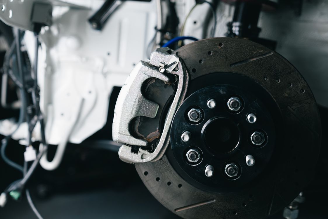 Close-up of an automotive brake disc and caliper illustrating brake system diagnosis and upgrades