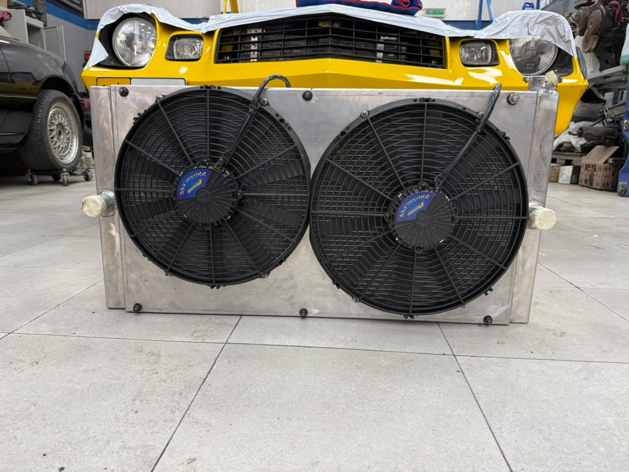 Custom aluminum performance radiator with dual electric fans built by MPG in Dubai for high-heat performance use