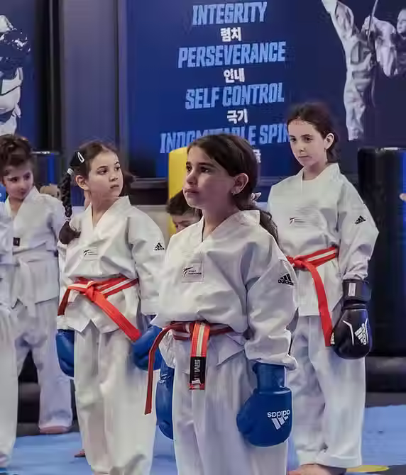 Group of young students in Taekwondo gear creating memorable moments at Mozhdeh Martial Arts party