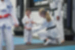 Young Taekwondo student receiving guidance, highlighting leadership and mentorship at Mozhdeh Martial Arts