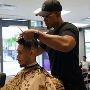 Julio fine-tuning a client’s fade haircut.