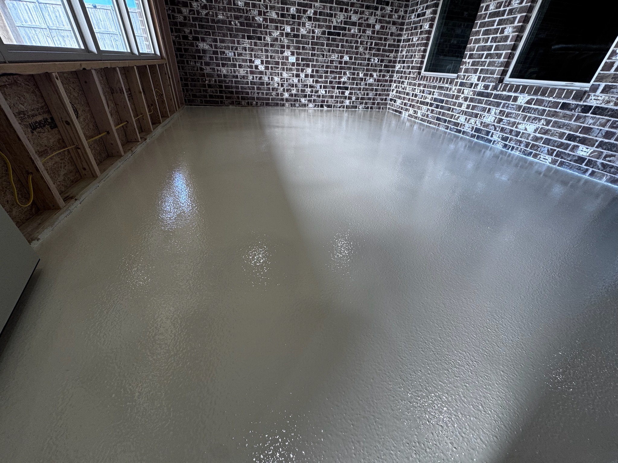 Finished concrete floor coating in a bright enclosed patio