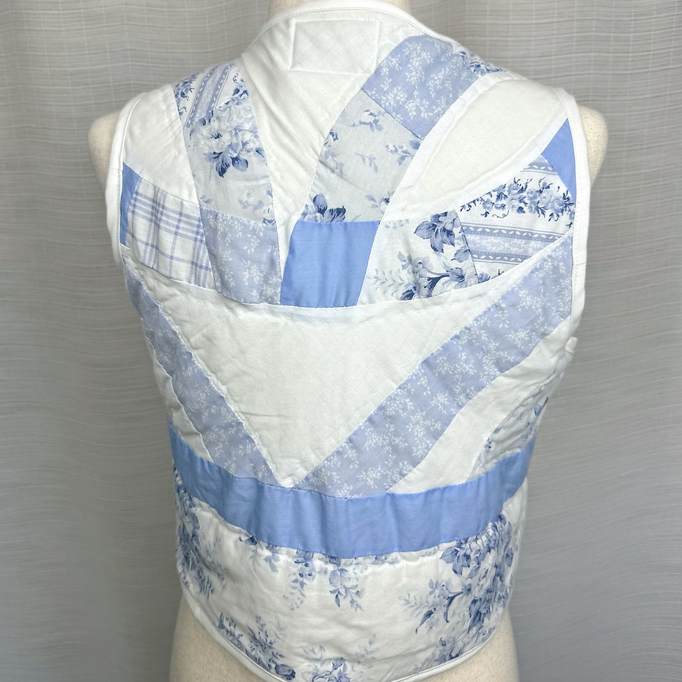 Thumbnail: Back view of blue floral patchwork quilted vest handmade from vintage quilt.