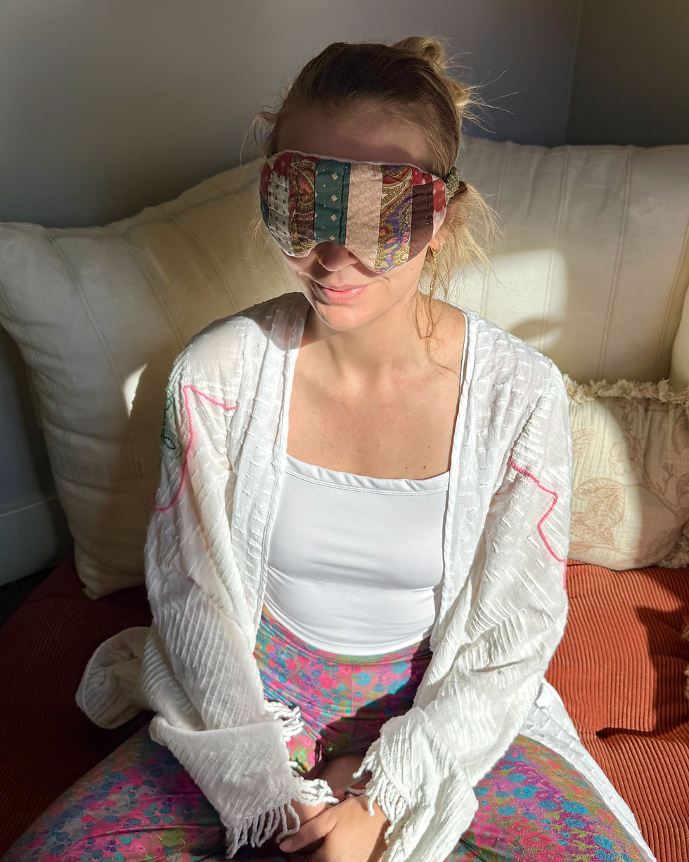 Thumbnail: Woman resting with an L/XL burgundy and sage patchwork vintage quilt eye mask during a quiet self-care session.