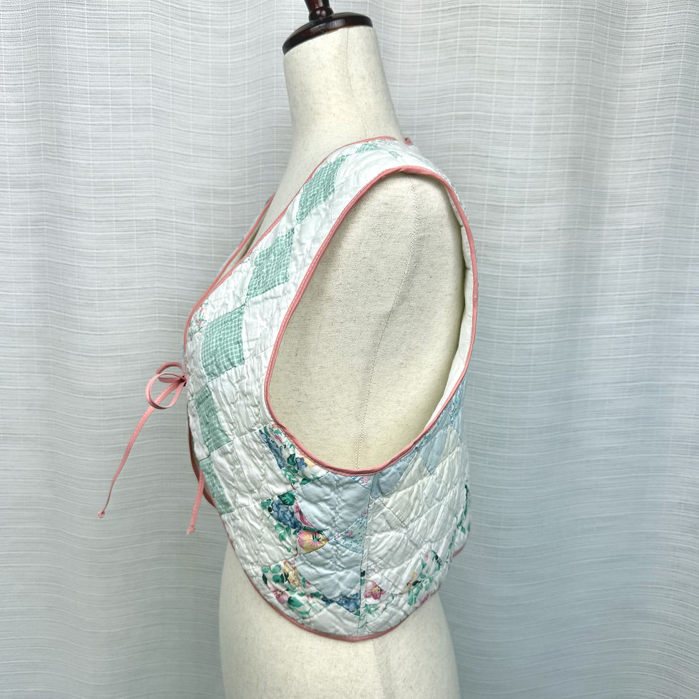 Thumbnail: Patchwork pink and blue quilted vest on mannequin, side view
