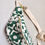 Thumbnail: Side angle of upcycled green floral fanny pack showing white zipper and gold hardware