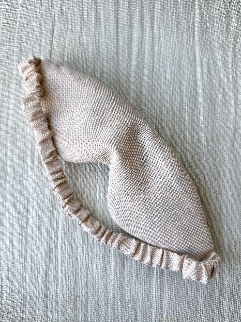 Thumbnail: Soft taupe linen-style backing fabric and matching ruffled elastic band on a sustainable upcycled textile eye mask.