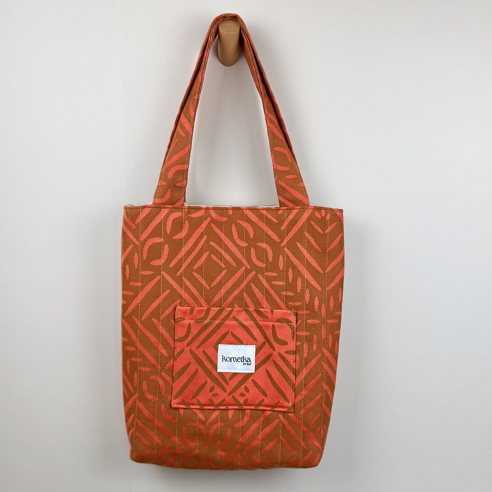 Thumbnail: Front view of orange quilted tote bag with outer pocket and white lining