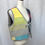Thumbnail: Angle view of vintage quilted vest with colorful and gray panels