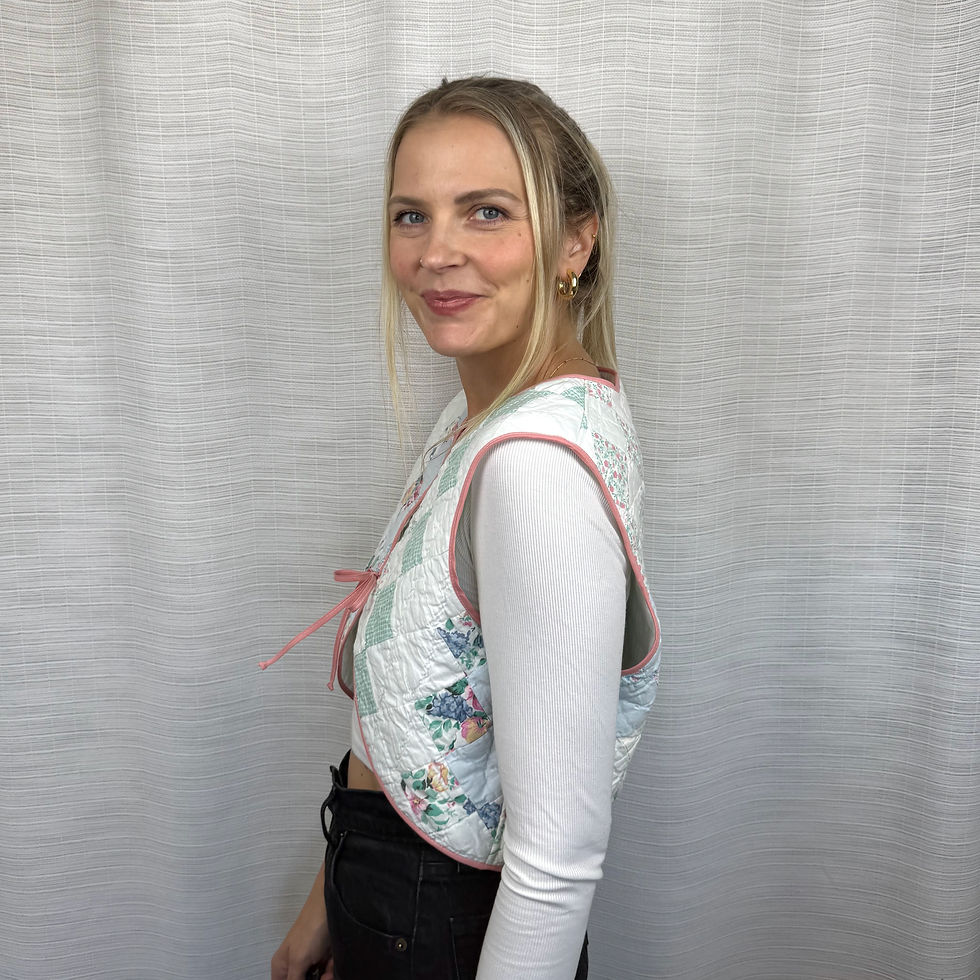 Side view of pastel patchwork quilted vest showing cropped fit