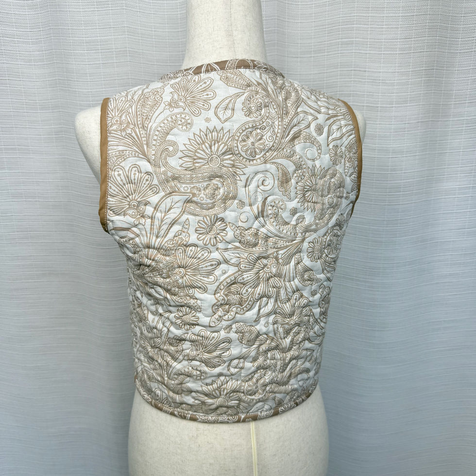 Thumbnail: Reversed side of quilted vest, white base with brown stitching, back view