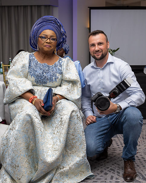 Photographer holding his camera beside his happy client