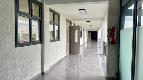 wide, well-lit school corridor at Fadhili International School with off-white accents and open access to classrooms
