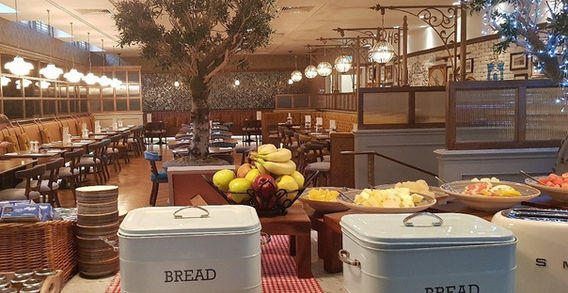 Restaurant interior with bread boxes, fruit, tables and chairs, MINDCLARITYretreats