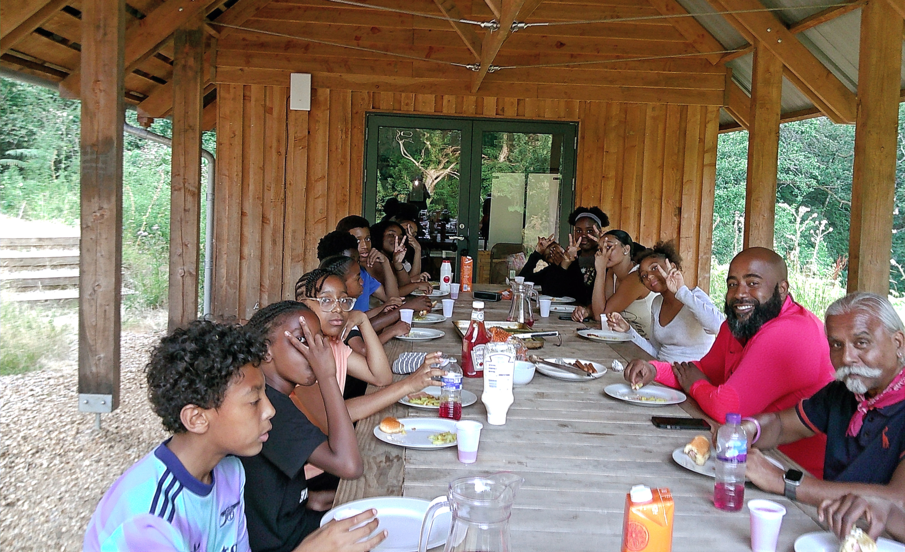 Young People enjoy eating dinner cooked in the outdoor kitchen.