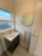 Simple and clean bathroom vanity design with round mirror