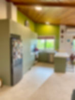 Original green kitchen with fridge and cabinetry before renovation by Sorted Home Solutions