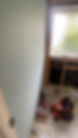 New plasterboard wall lining beside a window with tools on the floor mid-renovation