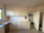 Finished galley-style kitchen with cream cabinetry and deep storage drawers by Sorted Home Solutions