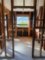 View through a timber-framed window opening during a full home reframe in Auckland
