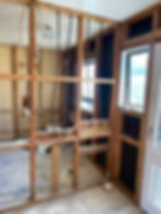 Exterior wall reframed and wrapped in weatherproof building paper