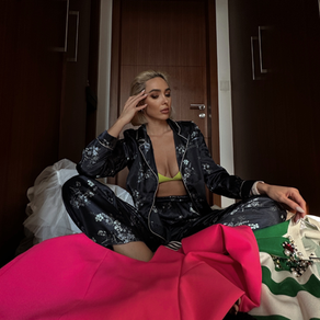 Anastasia sitting on a pile of clothes