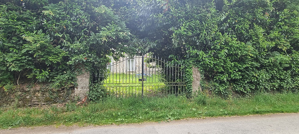 Chained up gate and overgrown garden of the Chateau de Chabannes