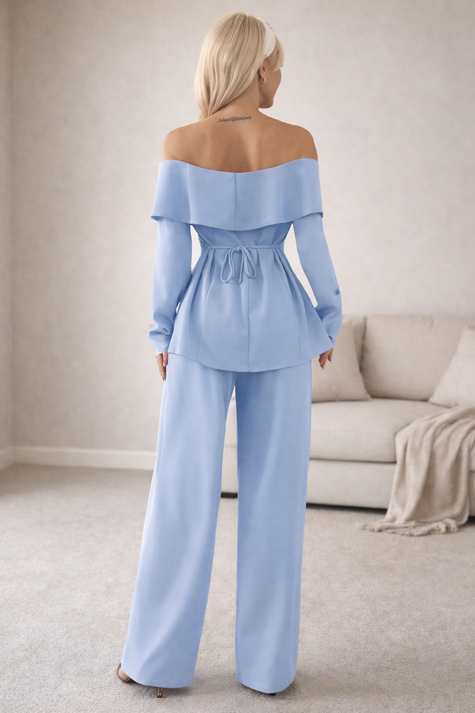 Woman in light blue off-shoulder top and wide-leg pants