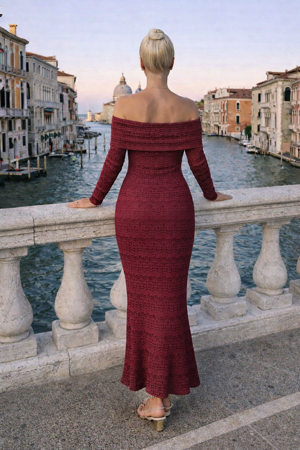 Woman in elegant red off-shoulder dress overlooking Venice canal