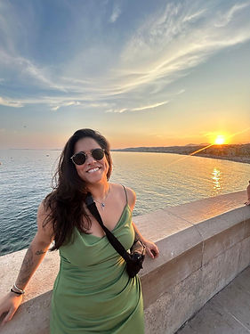 A woman with glasses smiling in the picture.