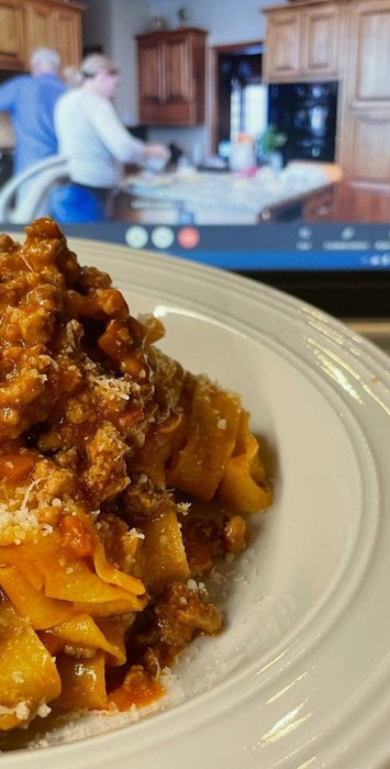 Couple celebrating their anniversary in a pasta making cooking class