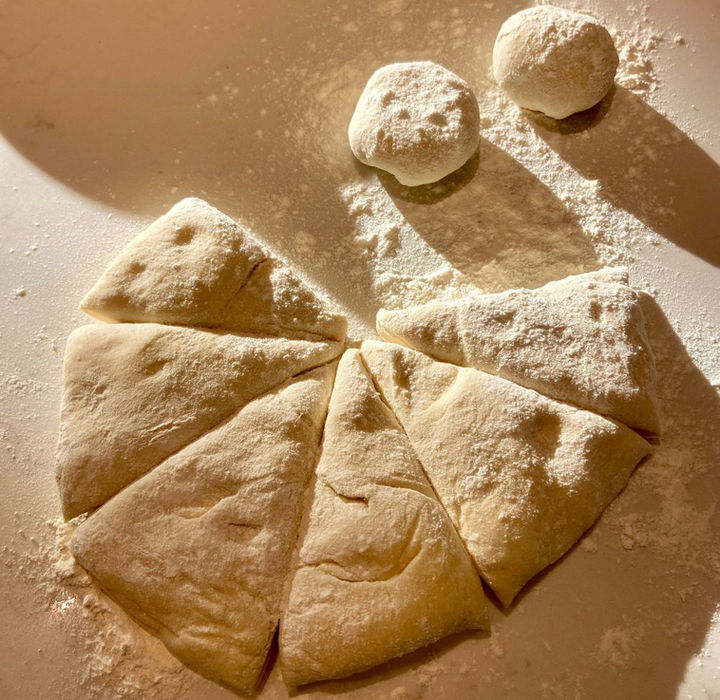 Homemade pita dough sitting on a counter in a virtual cooking class