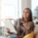 Thinking, credit card and online shopping on digital tablet by woman on sofa for payment o