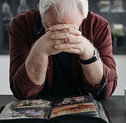 Person sitting with head in hands dealing with estate paperwork — Personal Property Inventory Sheet