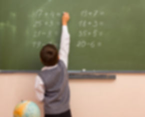 A boy solving a problem beyond his grade level.
