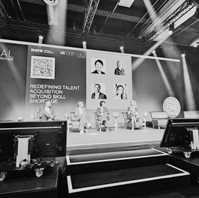 Laure Golly speaking on stage at business conference