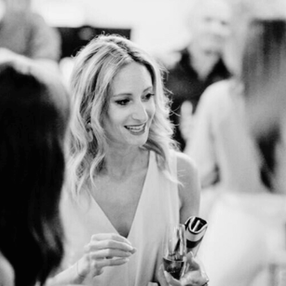 Laure Golly engaged in conversation at a networking event, demonstrating strategic relationship building