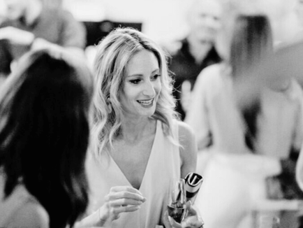 Laure Golly engaged in conversation at a networking event, demonstrating strategic relationship building