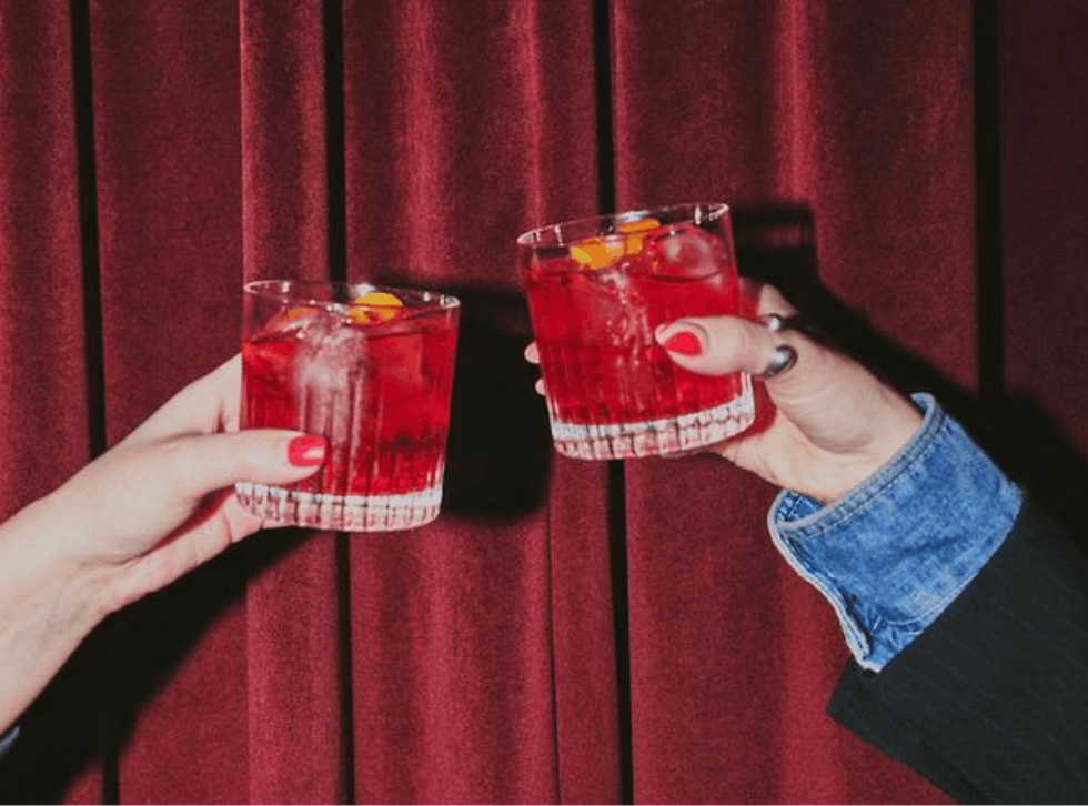 toast with two glasses of spanish sangria with ice and citrus slices