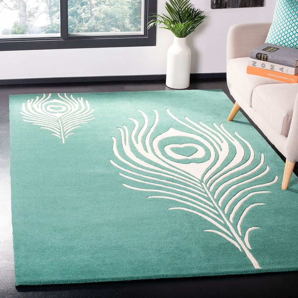 Peacock Feather Hand-Tufted Rug in seafoam teal with ivory feather motif in a modern living room setting.