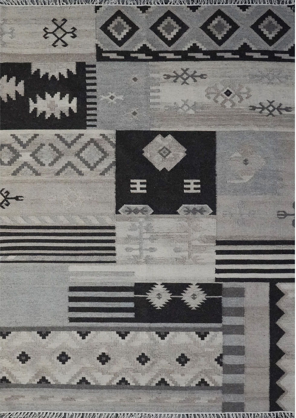 Patchwork Monochromatic Wool Kilim Flatweave Rug with high-contrast black and grey geometric panels and white fringe.