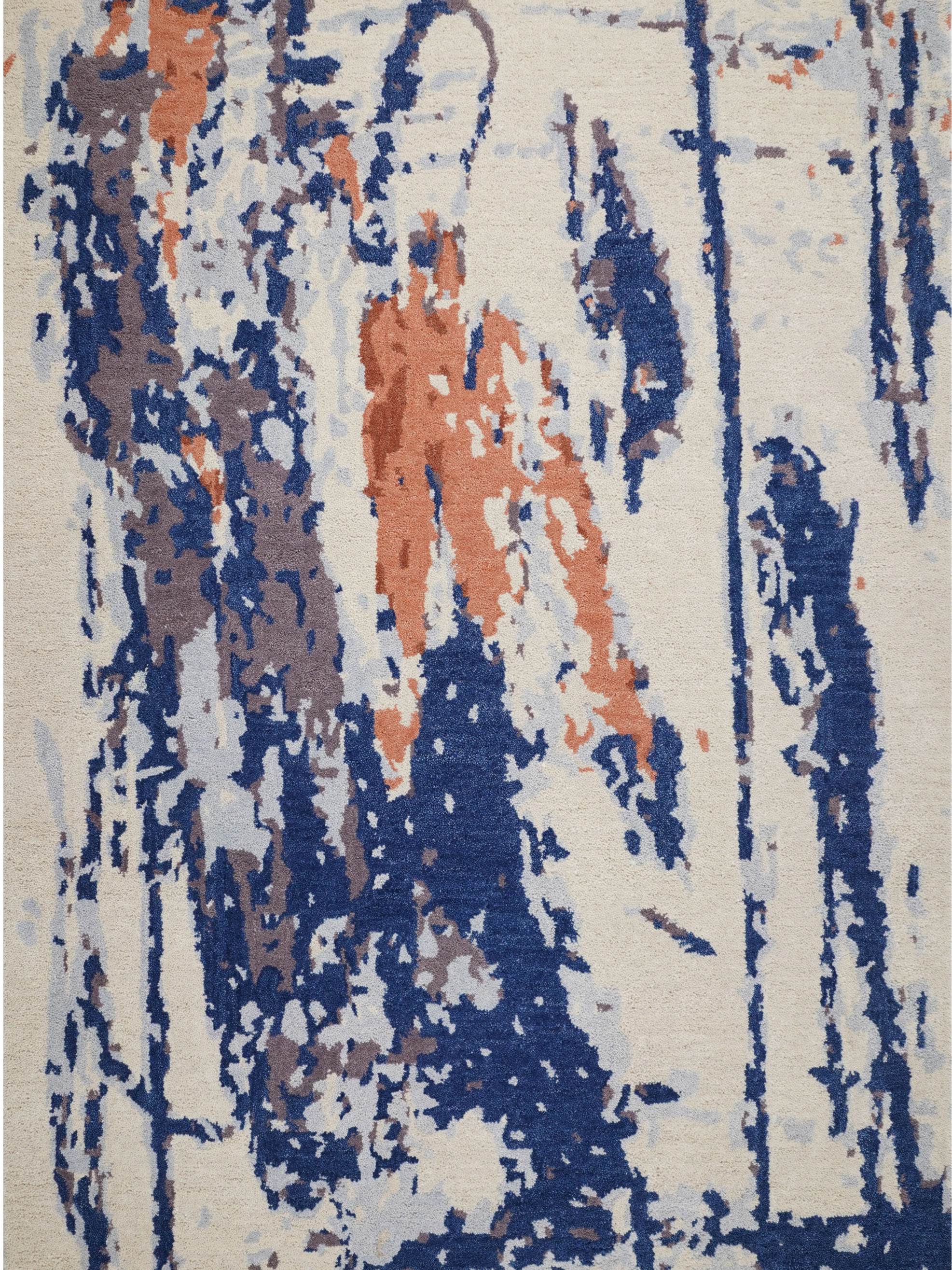 Abstract Expressionist Hand Tufted Navy and Terracotta Rug showing blue and orange painterly splatters on a cream background.