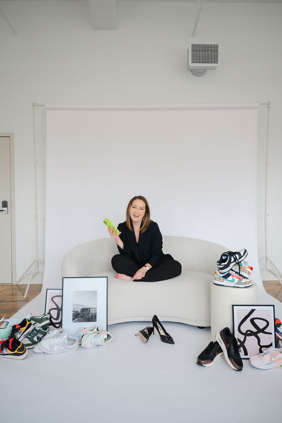 Barbara Caruso of AvantGarde Design sitting on couch, photographed by Carla Ten Eyck
