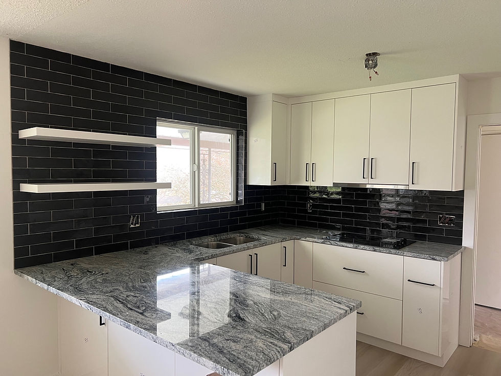 Remodeled kitchen in Washougal WA with white shaker cabinets, dark tile backsplash and new countertops