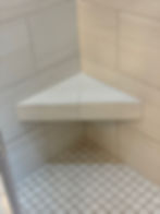 Corner shower bench by a handyman in Vancouver WA. Regrout