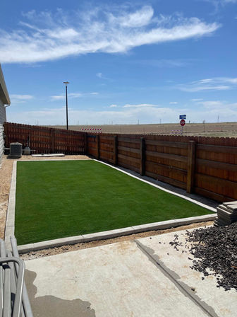 Beautiful Backyard with artificial turf installation. Concrete edging.