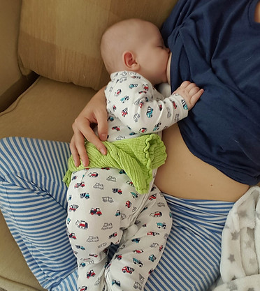 baby breastfeeding on the sofa
