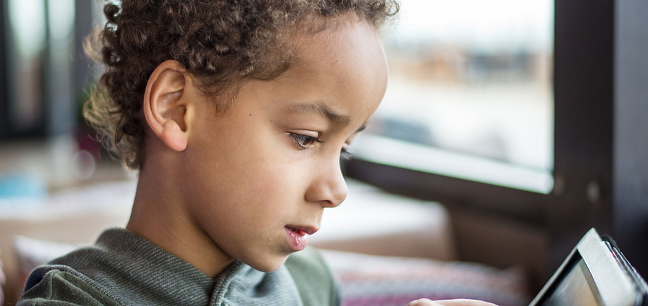 A Boy Reading on Tablet